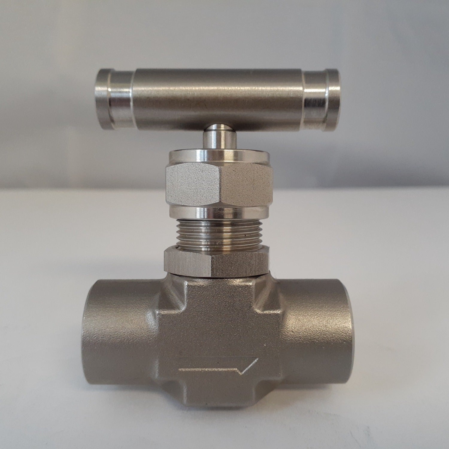 Needle valve flow direction